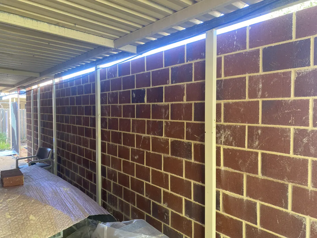 Red brick wall under a patio